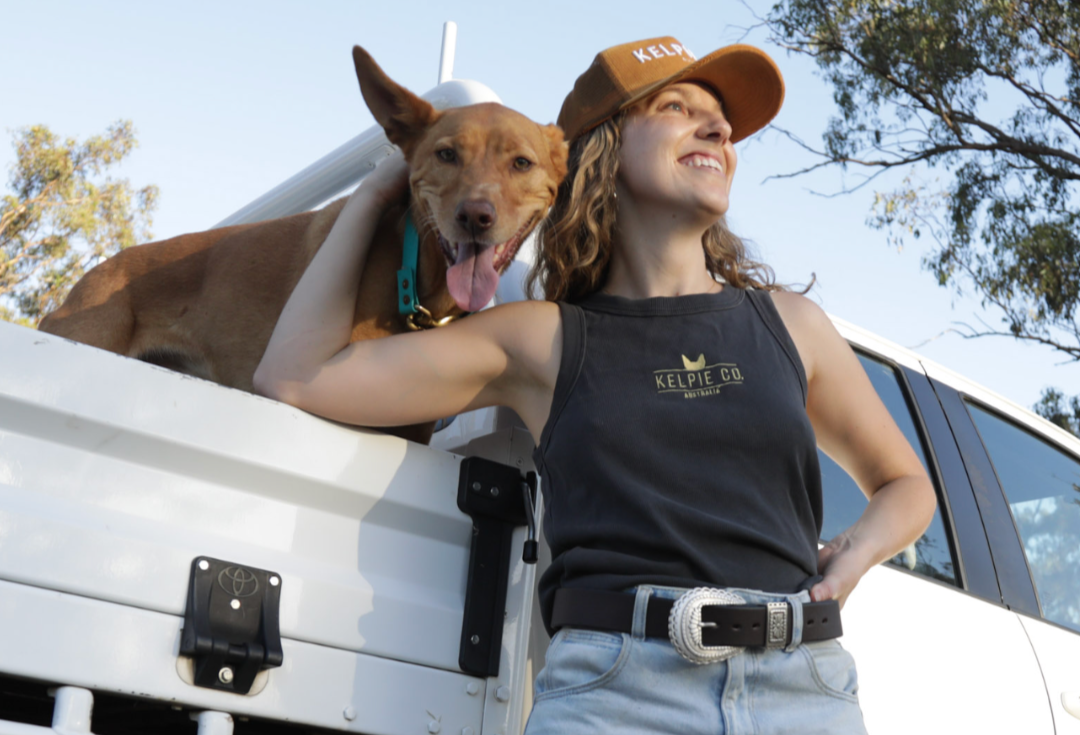 Kelpie with woman wearing Kelpie Co Hat and Tank Top